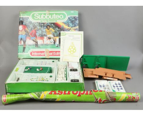 A boxed Subbuteo table soccer international edition game along with astro pitch in original packaging and accessories.