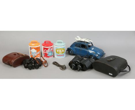A group lot to include tin plate model of a V. W. Beetle, two pairs of binoculars, three vintage style storage jars etc.