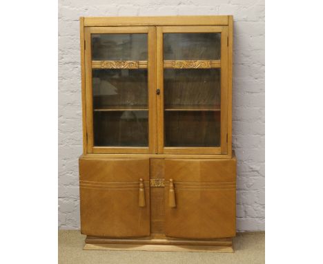A light oak glazed bookcase.