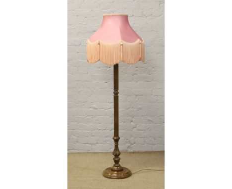 A carved mahogany column standard lamp and shade.