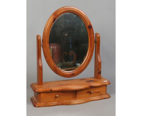 A pine toilet mirror with single drawer.