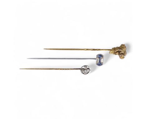 A gold stick pin - as a natural nugget, 4.9g, together with two further stick pins, one floral set with diamonds, the other i