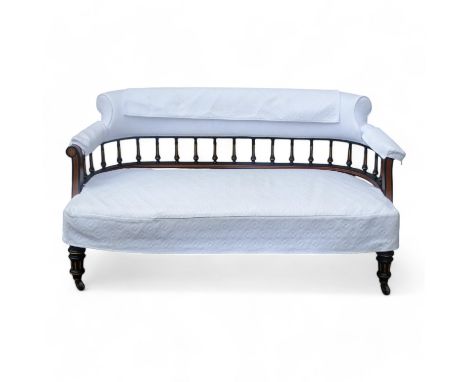 A late Victorian amboyna and ebonised sofa - the upholstered rail back above turned and gilt fluted supports, the seat raised