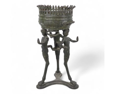 A 19th century bronze torchiere - the cauldron on three faun supports, 26cm high.