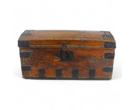 A 19th century pine dome topped trunk - with steel binding, brass studs and drop handles, 89 x 50 x 45cm.