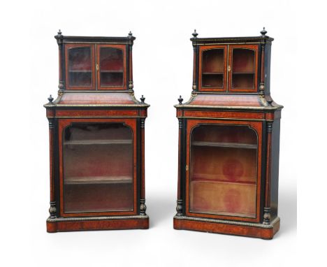 A pair of mid Victorian amboyna, ebony and gilt metal mounted display cabinets - the upper section with arched glazed panel d