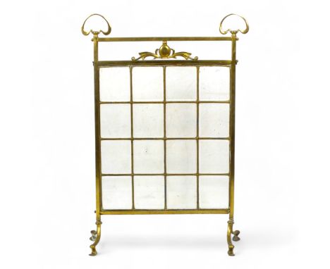 An early 20th century Art Nouveau style brass and glass fire screen - the brass frame fitted with sixteen bevelled clear glas