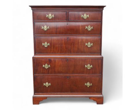 A George II walnut chest on chest - of small proportions, the upper section with an arrangement of two short and two long dra