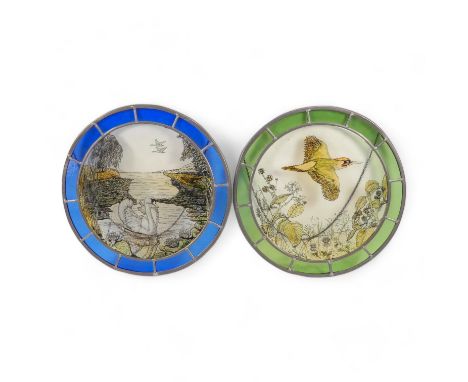 A pair of circular stained glass panels - decorated with wildlife scenes within a coloured glass band, each 38cm diameter. (2