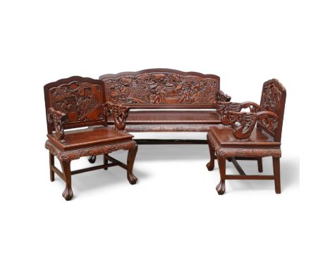 A late 20th century Chinese carved hardwood two seat sofa - the back carved with figures in an exotic landscape, with dragon 