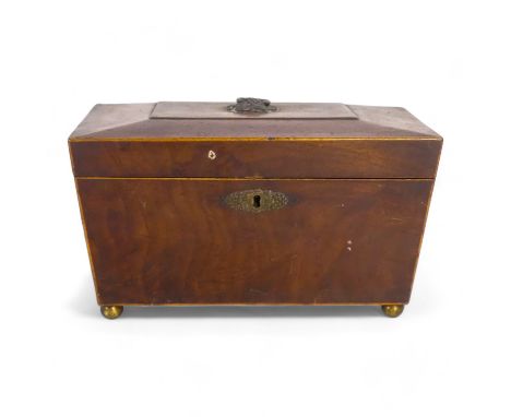 A Georgian mahogany tea caddy - of sarcophagus form with a void interior, raised on ball feet, 26cm wide.
