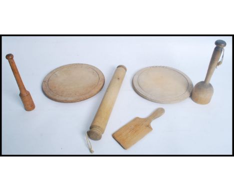 A collection of vintage 20th century Kitchenalia to include bread boards, butter paddles rolling pin etc. 40cms longest.