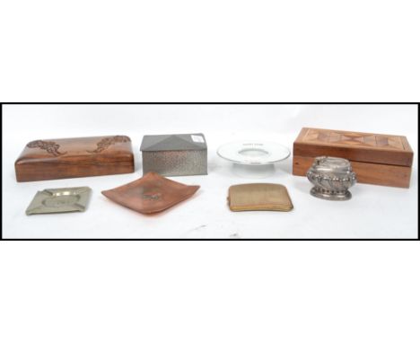 A collection of vintage 20th century smoking related items to include a cigarette case, advertising copper ashtrays, wooden a