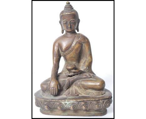 A 19th century Oriental Chinese bronze Buddha modelled in the lotus position holding a pot raised on a gadrooned pedestal bas