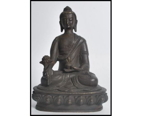 A 19th century Oriental Chinese bronze figurine of a Buddha in the lotus position raised on a pedestal base holding a pot. Me