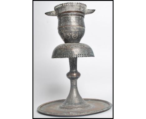 An 18th century Damascan / Indian temple copper oil lamp. The sectional lamp having a pieced edge design with calligraphy let