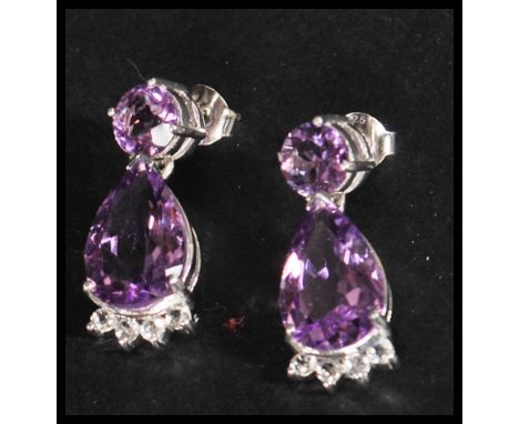 A pair of sterling silver and amethyst drop earrings having large faceted stones complete withi presentation box.