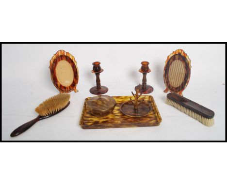 A collection of vintage 20th century tortoiseshell lucite dressing table set comprising off tray brush mirror candle stick ri