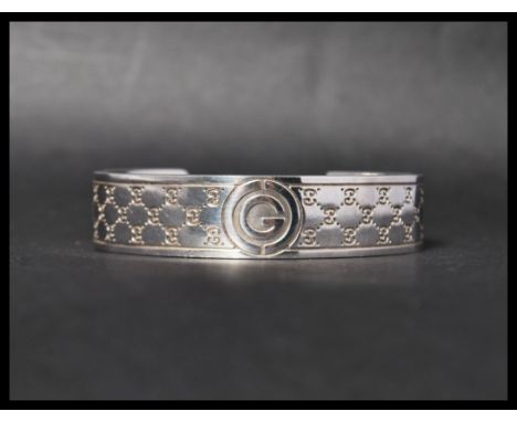 A hallmarked 925 silver designer Gucci cuff bangle bracelet . Marked Star&nbsp; 6971 AR 925 R Gucci Made in Italy. Weight 47.