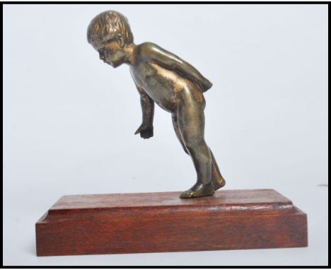 A 20th century gilt finished bronze study of a young child raised on a mahogany plinth base. Measures 12.5cms.