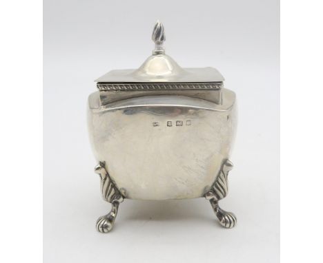 An Edwardian silver tea caddy, by William Devenport, Birmingham 1905, of shaped square form, on four paw feet, with a wrythen