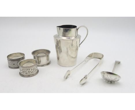 A collection of silver including a silver cream jug, by Charles Edwards, London, silver napkin rings, a pair of Victorian sil