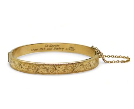 A 9ct gold bangle, with engraved decoration and inscription dated 1959, (af) weight 8.3gms Condition Report:Available upon re