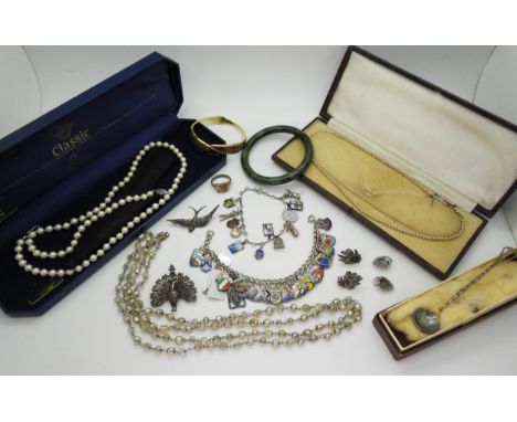 Two silver charm bracelets, one with extensive enamel place name charms the other with enamelled Dutch scenes and other charm