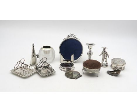 A collection of silver including a silver glass globular match striker, Birmingham, a pair of silver melba toast racks, by Jo