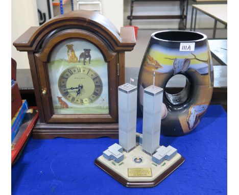 A Goebel Dali glass vase, a Danbury Mint Staffordshire Bull Terrier clock and a Twin Towers sculpture Condition Report:No con