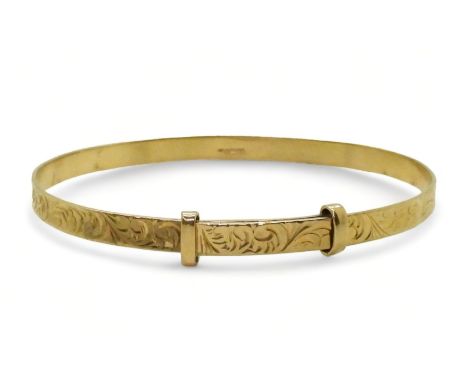 A 9ct gold expanding bangle with engraved pattern 9.1gms Condition Report:Available upon request