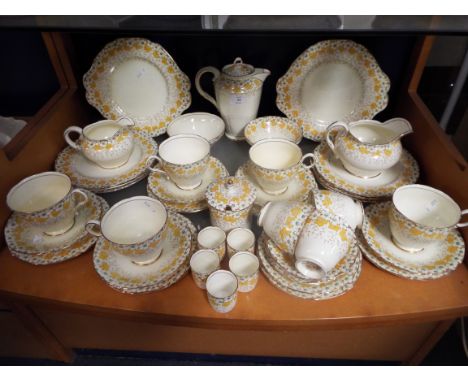 A Paragon 'May Blossom' Art Deco tea set comprising cake plates, tea pot, sugar bowls, cream and milk jug, egg cups, tea cups