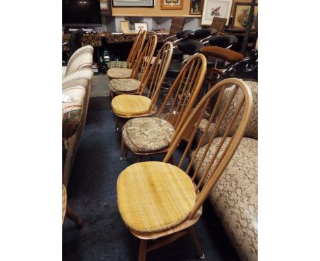 A set of six Ercol light elm stick back dining chairs