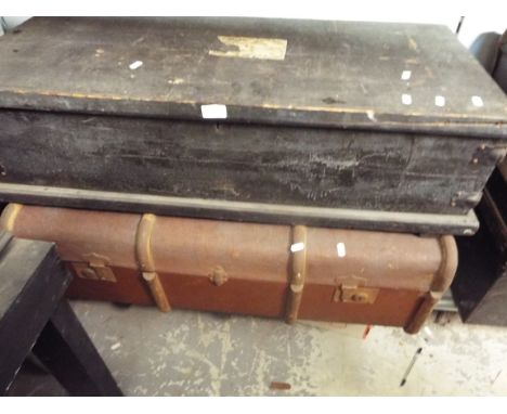 An early 20thC black painted pine twin handled trunk and a brown steamer trunk