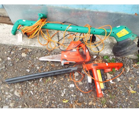 A Black & Decker chainsaw and reciprocating saw together with a Black & Decker strimmer
