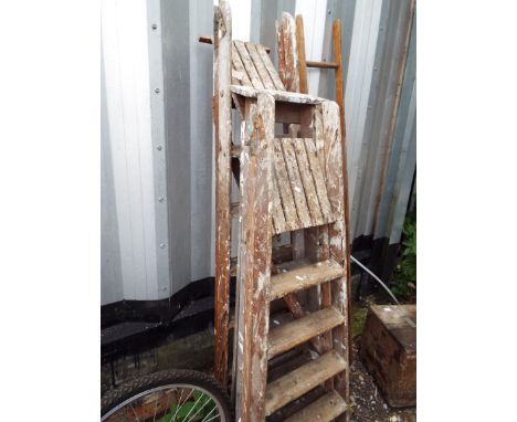 Three sets of wooden step ladders