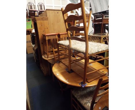 An Ercol light elm extending dining table with extra leaf, together with a four matching Ercol ladder back chairs