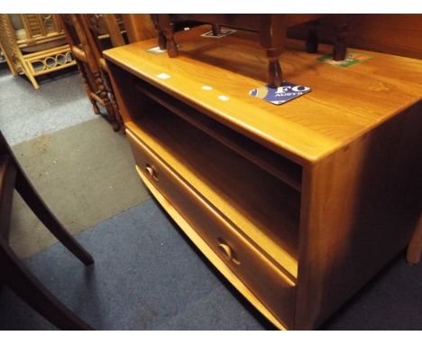 An Ercol light elm television stand fitted with two shelves above a single long drawer