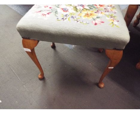 A floral tapestry upholstered stool raised on cabriole supports