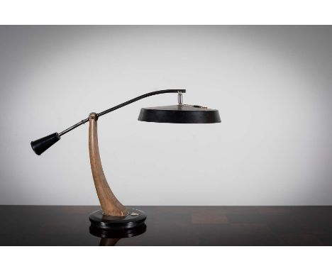 A 1960s EXECUTIVE DESK LAMP, BY FASE, the adjustable head on a chrome and wooden arm, with swivel base, bearing ,makers label