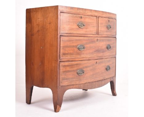 A George III early 19th century mahogany inlaid bow front chest of drawers. The chest having a straight top over a bank of tw