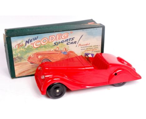 Codeg (UK) "New Sports Car", red bakelite body with black steering wheel and black wheels and hubs, clear plastic wind shield