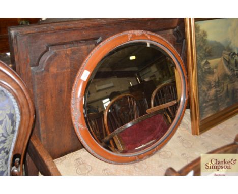 A decorative oval framed bevel edged wall mirror 