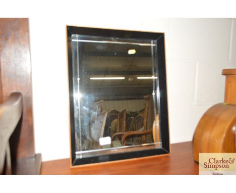 A modern bevelled wall mirror 