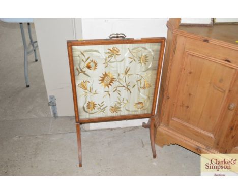 An Edwardian satin wood firescreen with embroidered panel