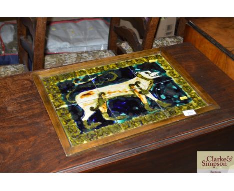 An unusual mid-20th Century pottery tile picture depicting a dog 