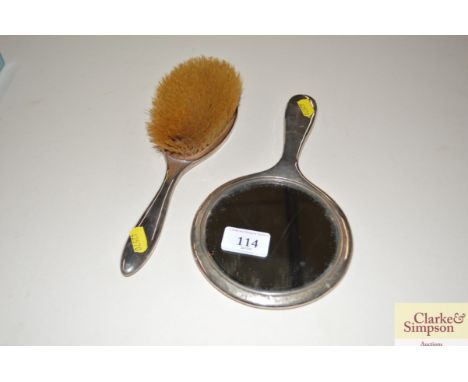 A silver backed hand mirror and brush