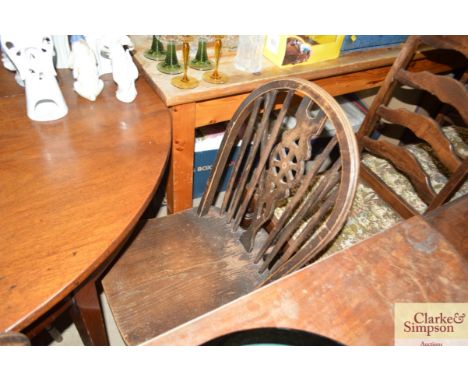 A set of four stick and wheel back dining chairs 