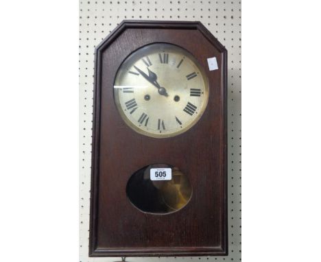 A vintage oak cased wall clock with silvered dial, visible pendulum and eight day gong striking movement