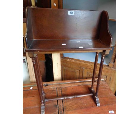 A vintage stained wood freestanding book trough with flanking pull-out slides, set on slender supports - for re-assembly